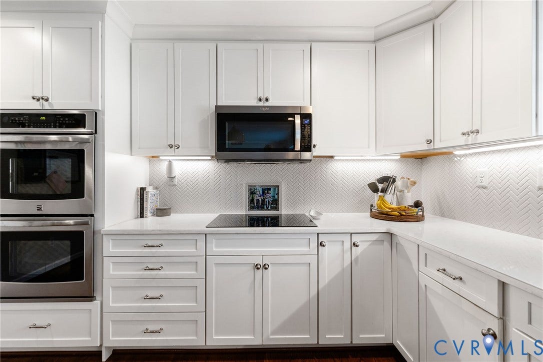 1109 Swissvale Place, Henrico, VA 23229 White shaker cabinetry paired with a herringbone tile backsplash, under-cabinet lighting, and a built-in double oven