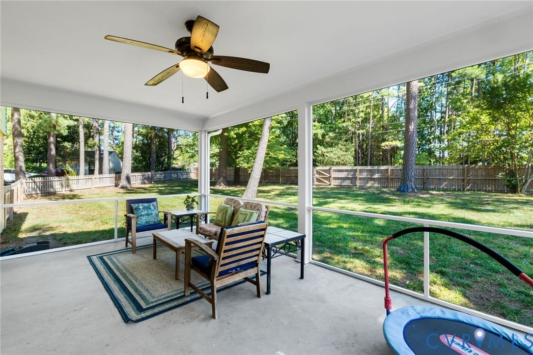 1109 Swissvale Place, Henrico, VA 23229 Expansive screened porch with a ceiling fan, concrete flooring, and a large fenced backyard with mature trees