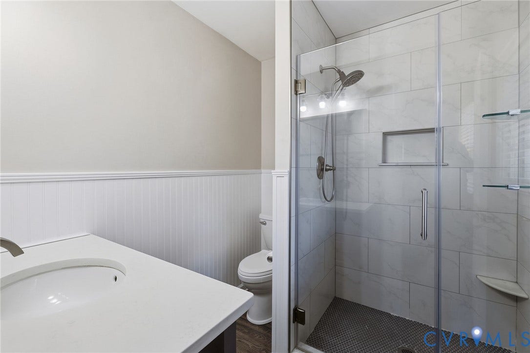 1109 Swissvale Place, Henrico, VA 23229 Walk-in shower with clear glass enclosure, tiled walls, and built-in shelving