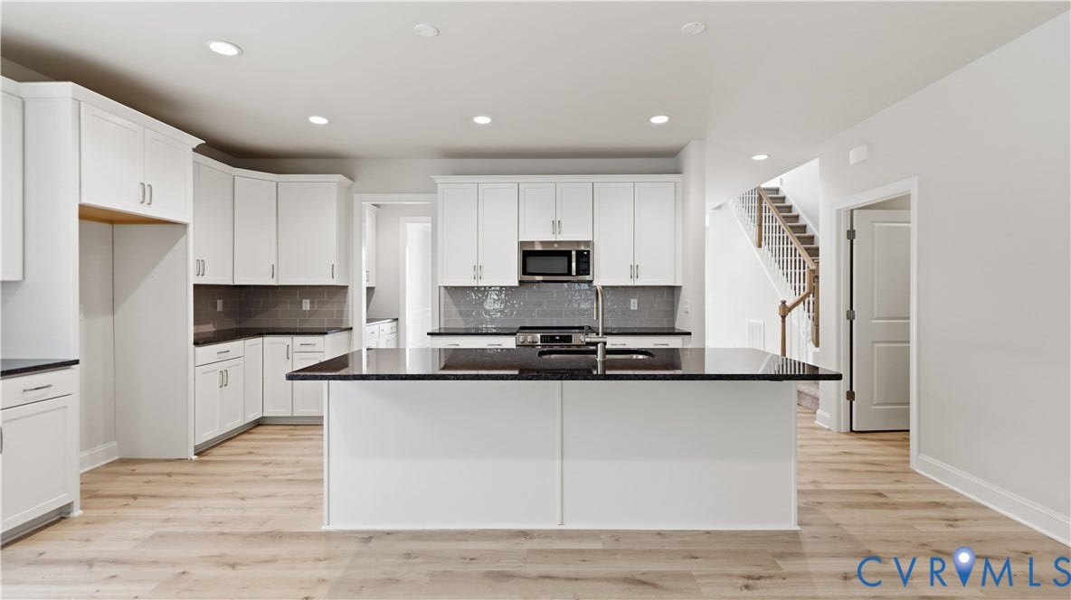 12344 Garnet Parke Circle, Short Pump Area, Glen Allen, VA 23059 Kitchen featuring white cabinetry, dark stone countertops, stainless steel appliances, a center island with sink, and wood-finish flooring