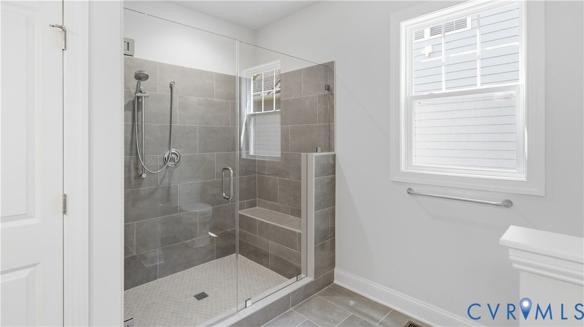 12344 Garnet Parke Circle, Short Pump Area, Glen Allen, VA 23059 Glass-enclosed shower with a built-in bench, large format wall tiling, and hexagonal floor tiling