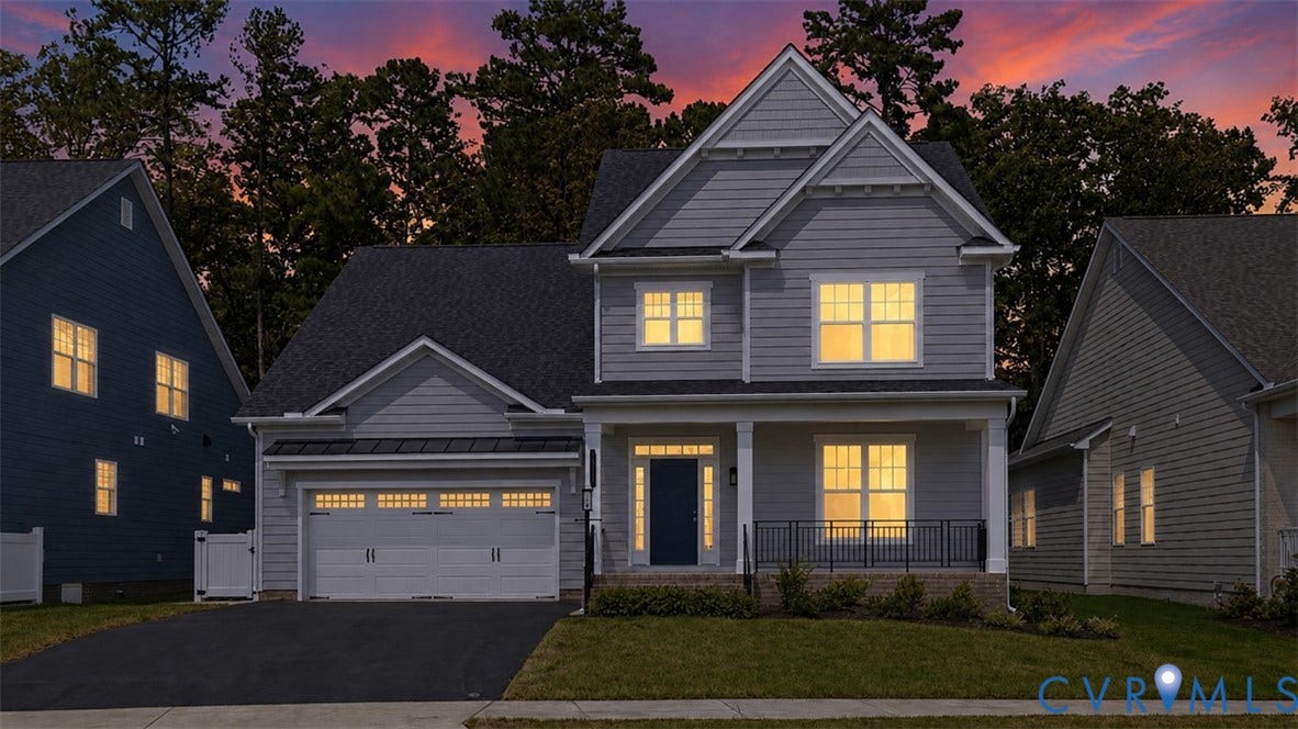 12344 Garnet Parke Circle, Short Pump Area, Glen Allen, VA 23059 Two-story residence featuring light gray siding, a covered front porch, a two-car garage, dark asphalt driveway, and a manicured lawn