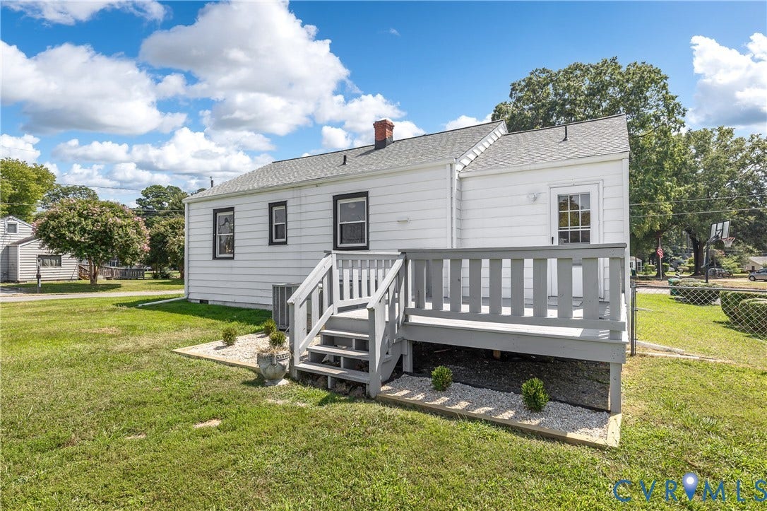White siding exterior with black trim windows