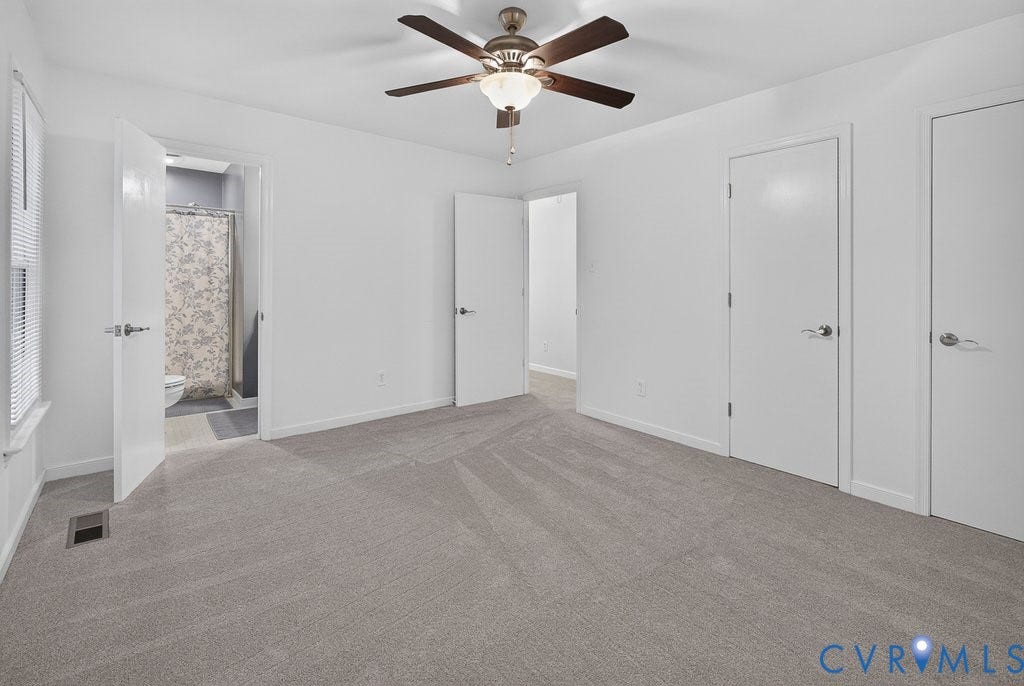 3112 Castlebury Drive, Chester, VA 23831 Neutral tone carpeting, white walls, ceiling fan with integrated lighting, multiple white interior doors, and window with blinds