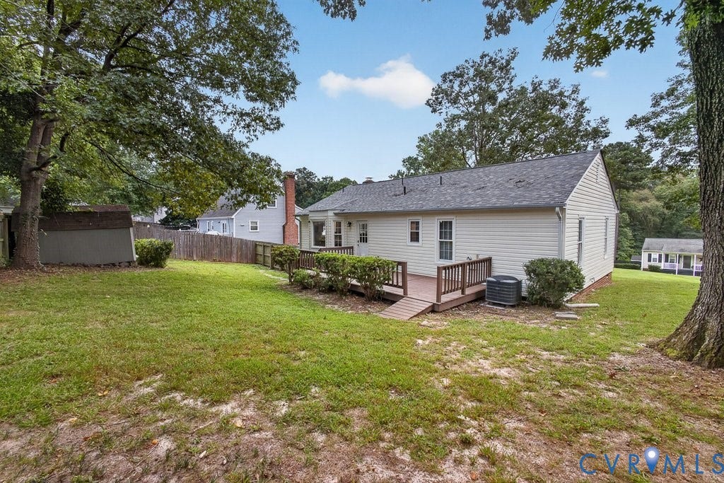 3112 Castlebury Drive, Chester, VA 23831 Expansive yard featuring a wood deck with ramp, white siding, and a storage shed