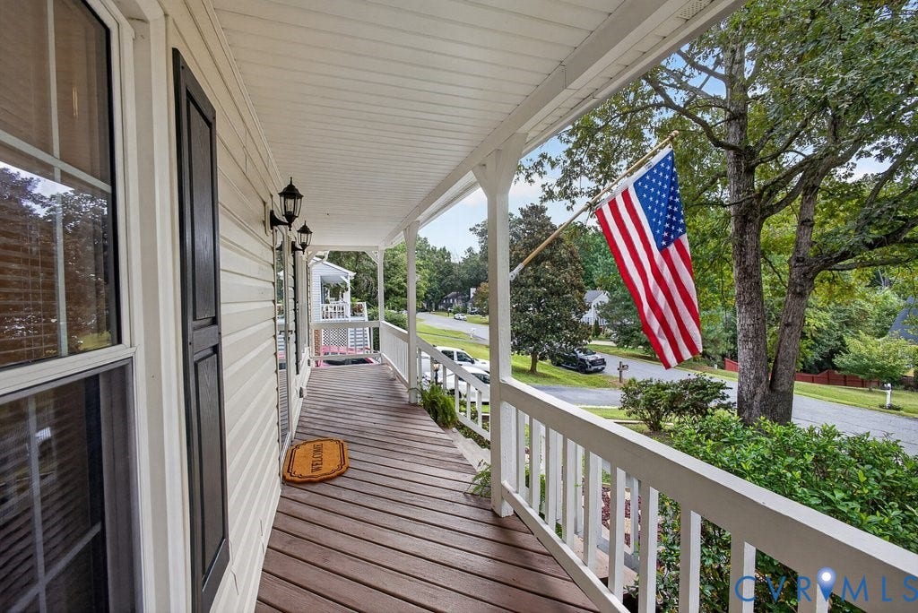 3112 Castlebury Drive, Chester, VA 23831 Expansive covered porch with wood-finish decking, white railings, and siding