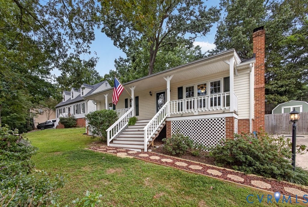 3112 Castlebury Drive, Chester, VA 23831 Front facade with a covered porch, white railing, and brick foundation