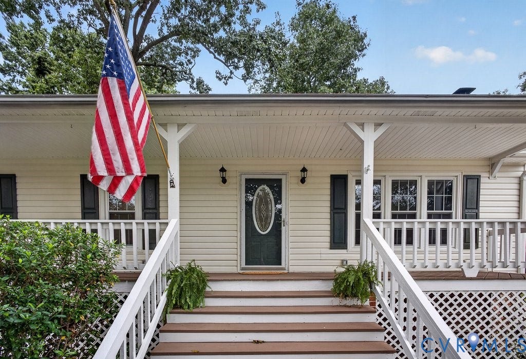 3112 Castlebury Drive, Chester, VA 23831 Covered front porch with a dark-paneled entry door featuring an oval glass insert