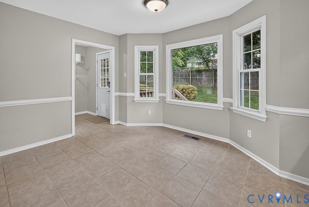 3112 Castlebury Drive, Chester, VA 23831 Neutral-toned tile flooring, light gray walls with chair rail molding, and multiple windows providing natural illumination