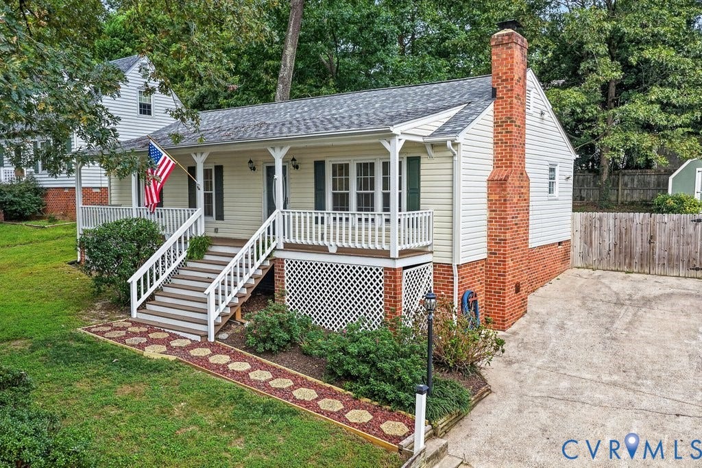 3112 Castlebury Drive, Chester, VA 23831 Charming exterior with a covered porch, white railings, and a prominent brick chimney