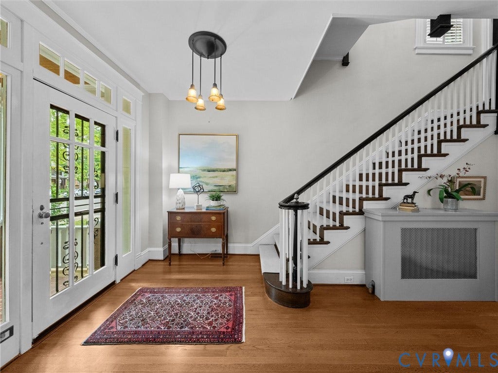 3403 W Franklin Street, Museum District, Richmond, VA 23221 Wood-finish flooring throughout the entry, staircase with white risers and dark wood treads, white balusters, and dark wood handrail