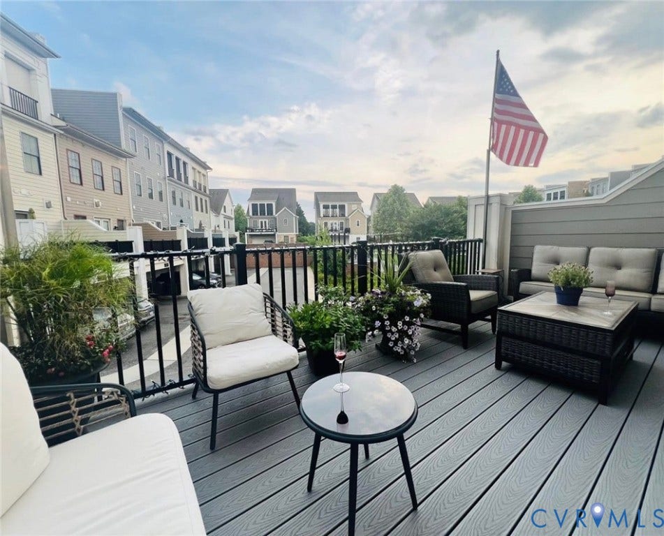 3332 Haydenpark Lane, Henrico, VA 23233 Expansive outdoor deck featuring composite decking, black metal railings, and a privacy wall