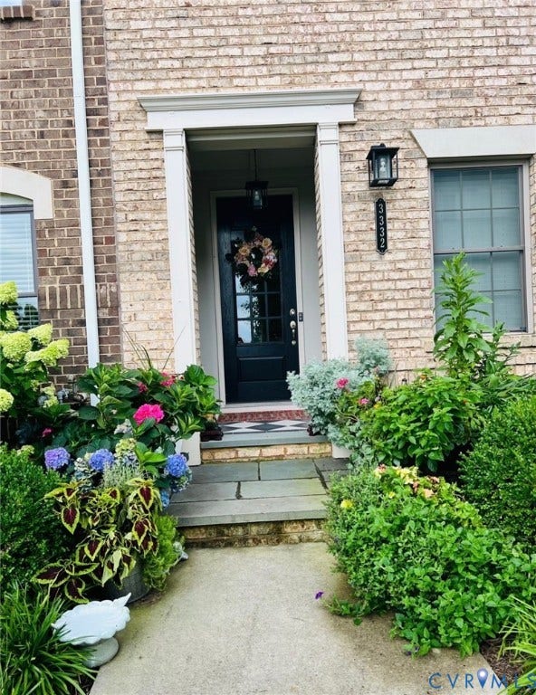 3332 Haydenpark Lane, Henrico, VA 23233 Brick exterior with a covered entry, decorative door surround, and stone entryway
