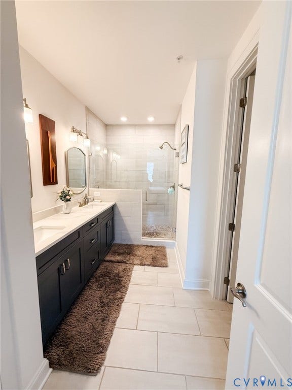 3332 Haydenpark Lane, Henrico, VA 23233 Dual vanity with undermount sinks and dark cabinetry, glass-enclosed shower, tiled shower surround, recessed lighting, and tile flooring