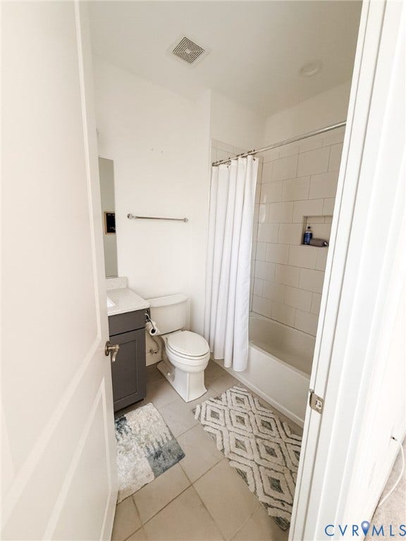 3332 Haydenpark Lane, Henrico, VA 23233 Bathroom featuring a single vanity with a dark gray cabinet, white countertop, white subway tile shower surround, built-in shower niche, and light-toned floor tiling