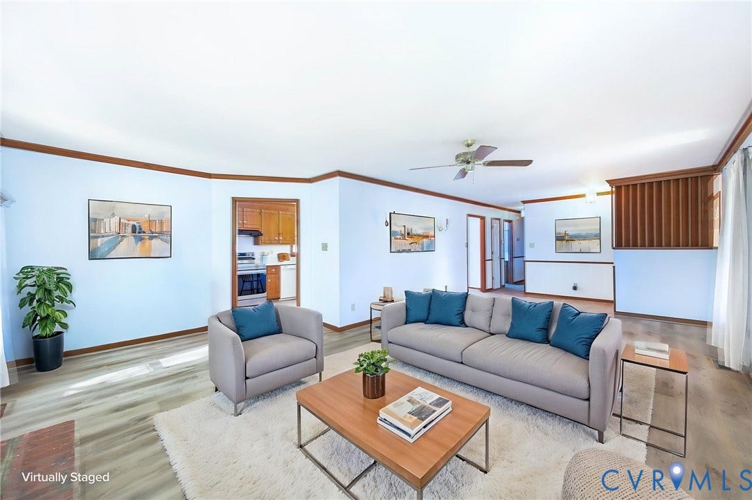 AI STAGED Spacious interior with wood-finish flooring, light blue walls, and warm wood trim