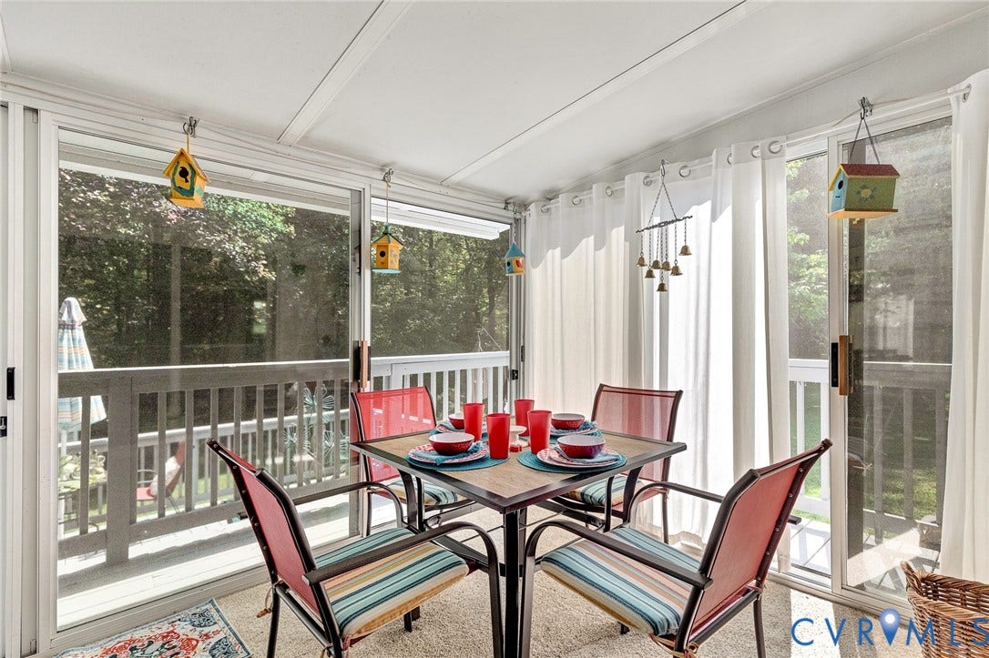 Enclosed porch featuring multiple sliding glass doors, a white slat ceiling, and permanent curtain rods