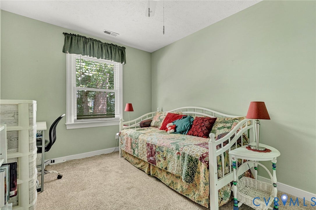 Wall-to-wall carpeting and a single window with blinds