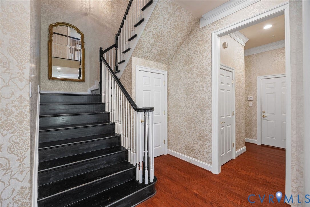 Stairs Leading Upstairs, Powder Room, Two Car Garage Entrance.