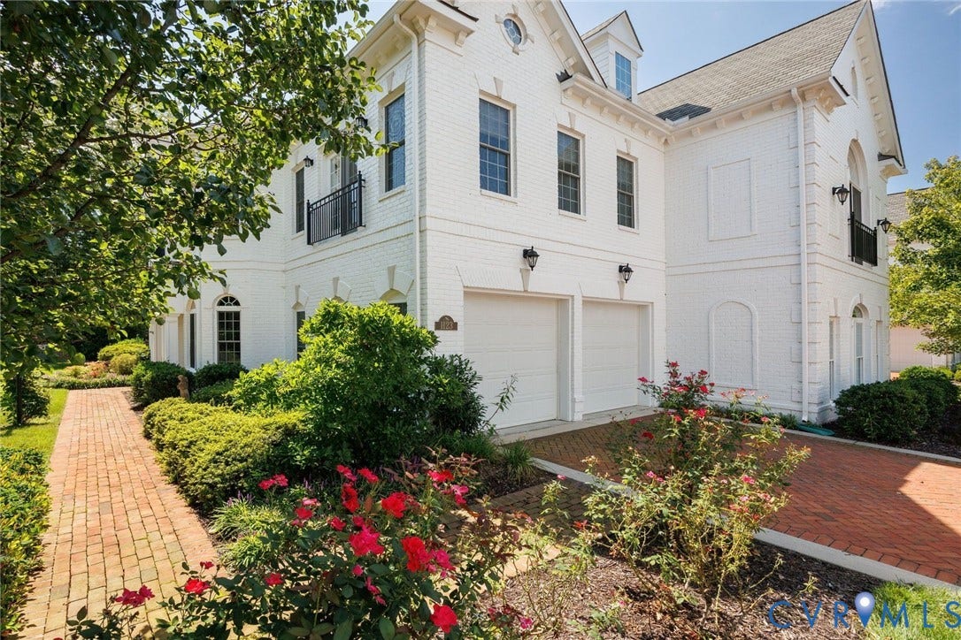 Two car garage, walkway to entrance.
