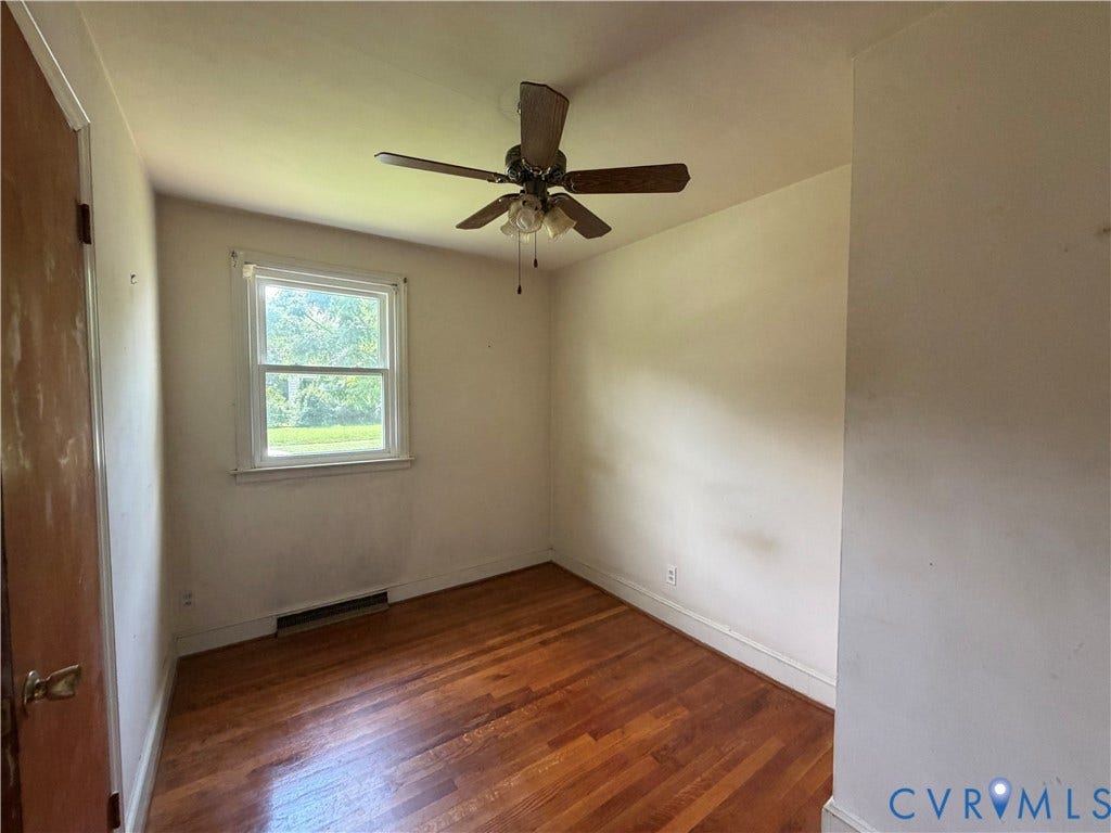 Hardwood flooring, single window, ceiling fan with light fixture, and neutral wall tones