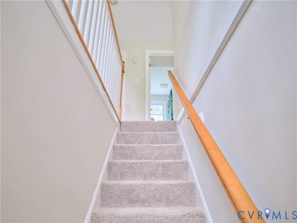 1311 Santa Rosa Road, Henrico, VA 23229 Carpeted staircase with light-toned walls, white trim, and a natural wood handrail