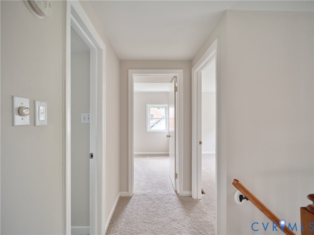 1311 Santa Rosa Road, Henrico, VA 23229 Carpeted hallway with light-toned walls, white trim, and a wood handrail