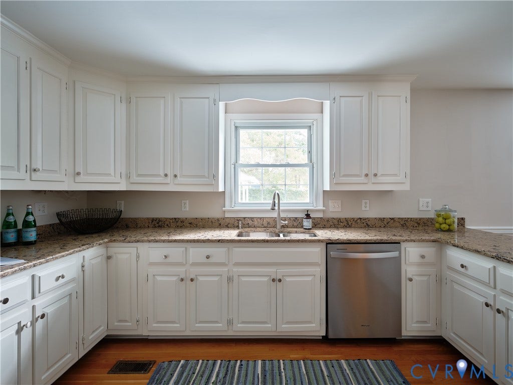 1311 Santa Rosa Road, Henrico, VA 23229 White cabinetry with crown molding, light-toned countertops, stainless steel sink with a gooseneck faucet, and a built-in stainless steel dishwasher
