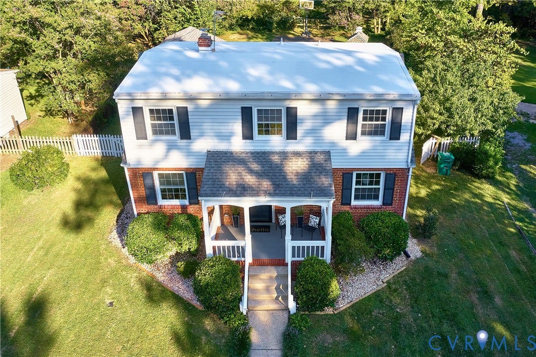 1311 Santa Rosa Road, Henrico, VA 23229 Two-story residence featuring a covered front porch, white siding, and a brick lower exterior