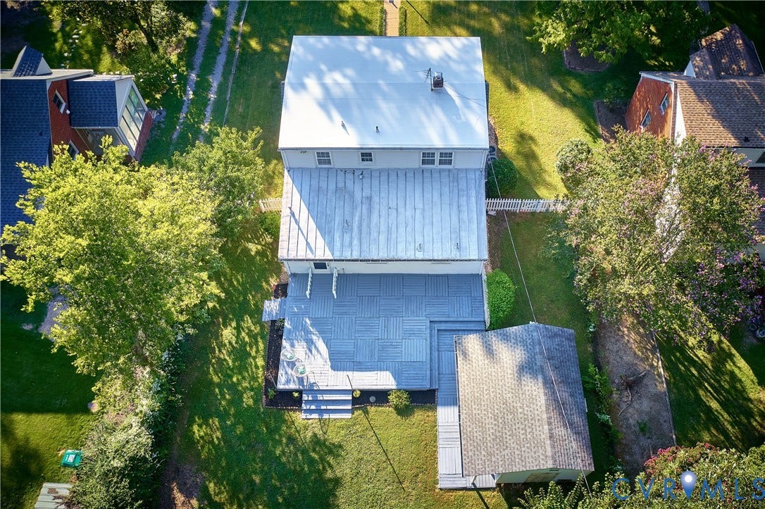 1311 Santa Rosa Road, Henrico, VA 23229 Expansive backyard featuring a large deck with patterned tile, manicured lawn, and mature trees