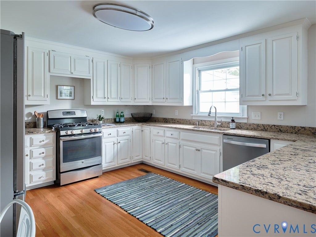 1311 Santa Rosa Road, Henrico, VA 23229 White cabinetry with crown molding, stainless steel appliances, granite countertops, hardwood flooring, and a stainless steel sink with a gooseneck faucet