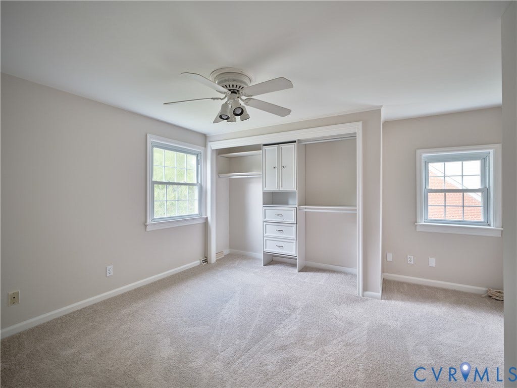 1311 Santa Rosa Road, Henrico, VA 23229 Plush carpet flooring, ceiling fan with integrated lighting, two windows with white trim, and a built-in closet system featuring drawers and cabinetry