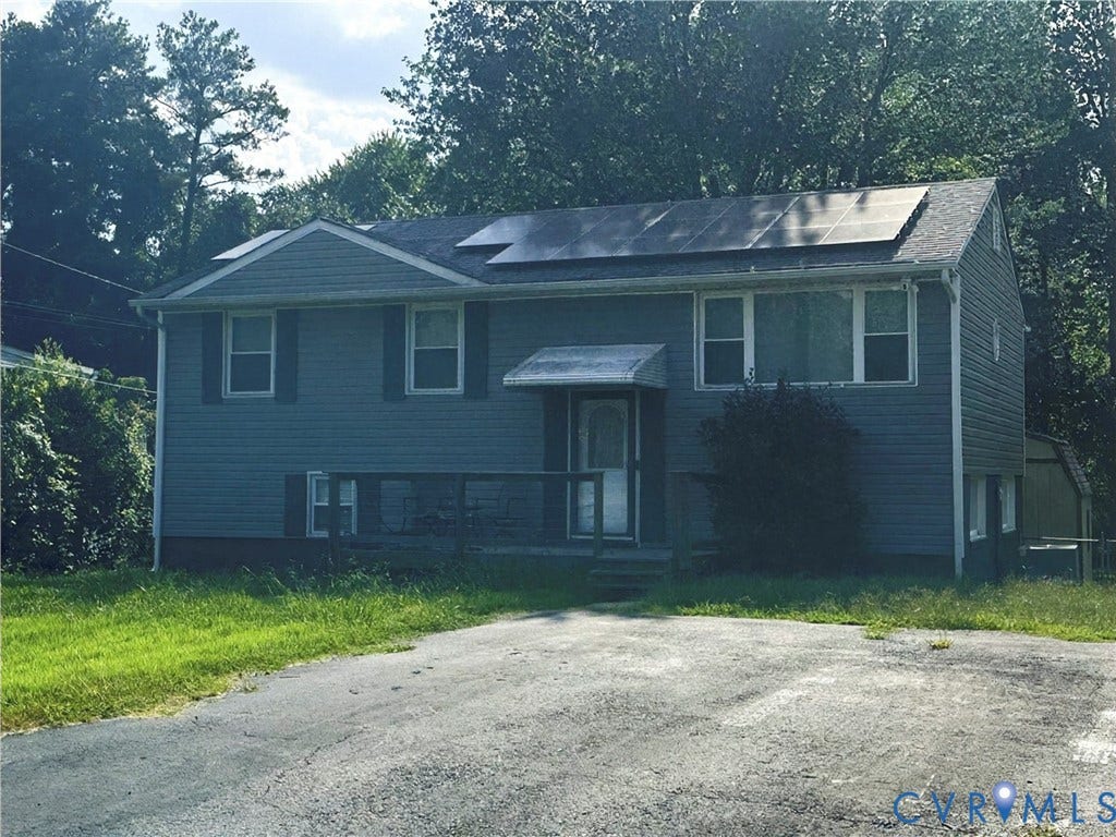4602 Mizar Road, Henrico, VA 23231 Split-level residence featuring solar panels, a gabled roof, and a front porch with an awning