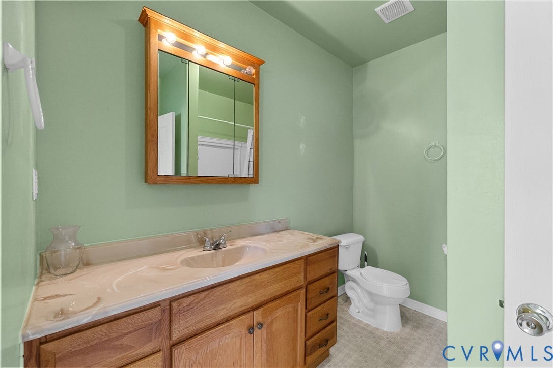 2314 Ingram Avenue, Richmond, VA 23224 Bathroom with a wood-finish vanity, integrated sink, and light-toned countertop