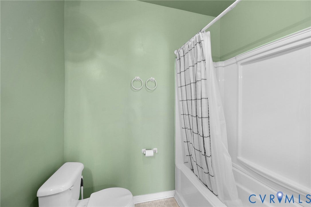 2314 Ingram Avenue, Richmond, VA 23224 White toilet with a built-in bidet feature, white acrylic tub, and a shower/tub combination unit