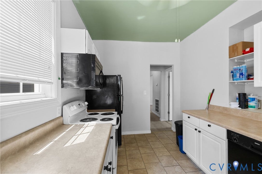 2314 Ingram Avenue, Richmond, VA 23224 Kitchen featuring white cabinetry, light-toned countertops, a white electric range, and black appliances