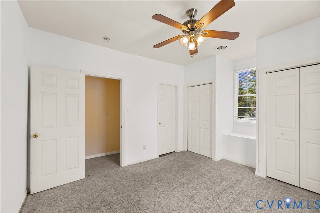 2314 Ingram Avenue, Richmond, VA 23224 Carpeted flooring, ceiling fan with integrated lighting, window with horizontal blinds, built-in shelf below window, and two bi-fold closet doors