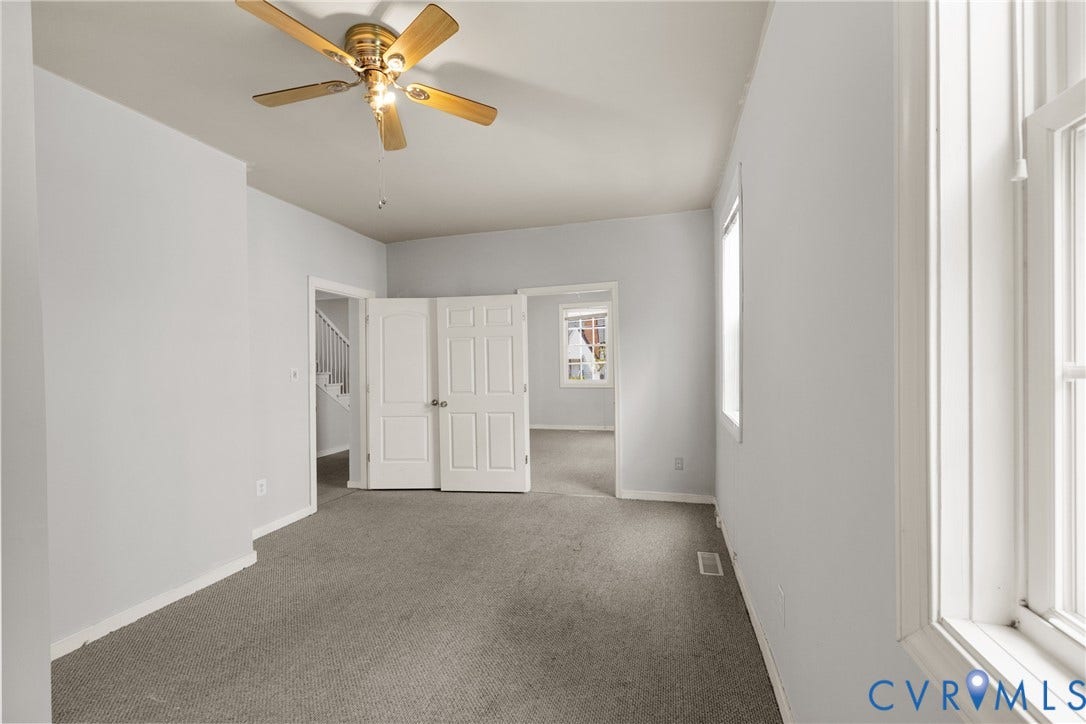 2314 Ingram Avenue, Richmond, VA 23224 Neutral carpeting, ceiling fan, white paneled doors, and natural light from a double-hung window
