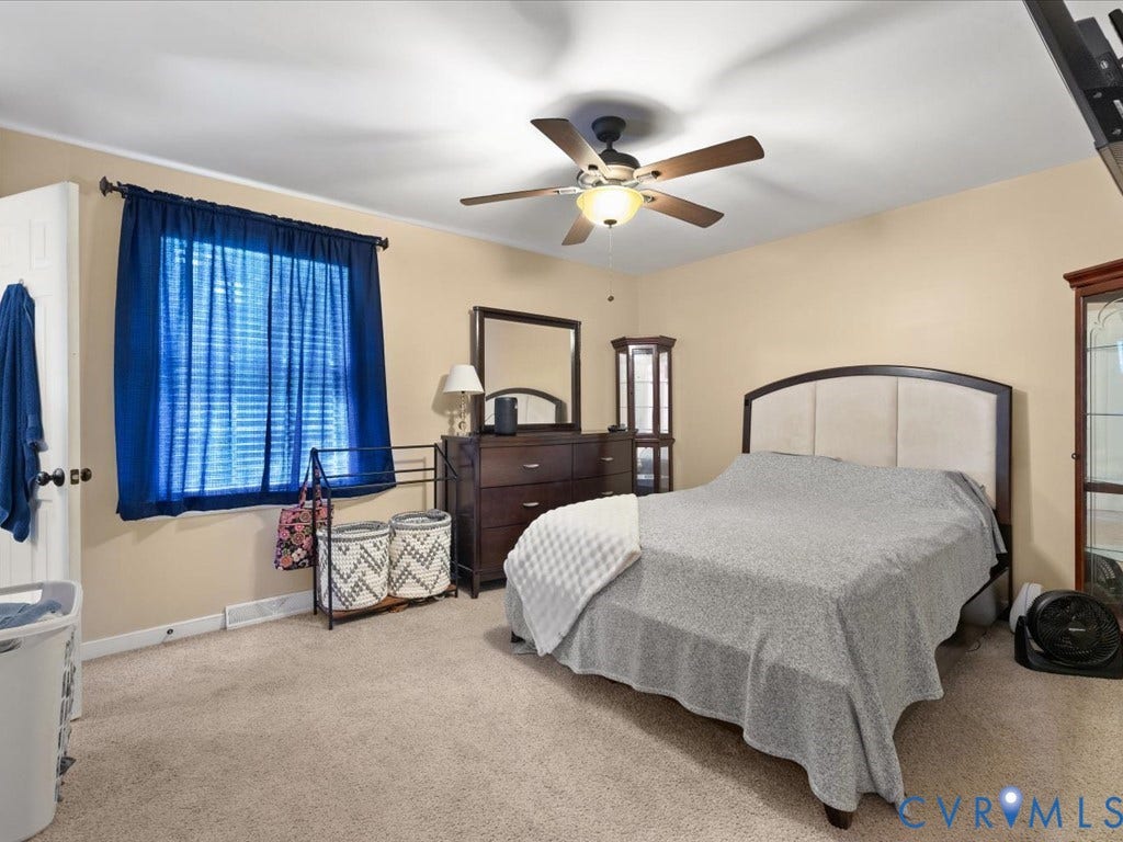 Neutral-toned walls complement the carpeted flooring