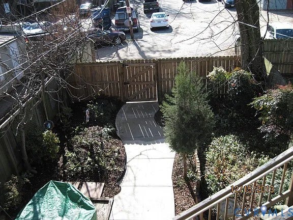 2609 W Main Street, The Fan, Richmond, VA 23220 Fenced outdoor area featuring a concrete pathway, established plantings, and a wooden gate