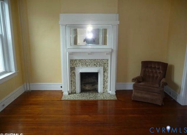 2609 W Main Street, The Fan, Richmond, VA 23220 Wood flooring, decorative fireplace with tiled surround, white trim, and a built-in overmantel mirror