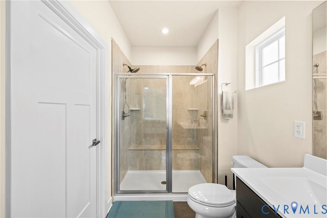 11319 Vulcan Lane, Bermuda, Chester, VA 23831 Glass-enclosed shower with dual shower heads, integrated shower bench, and tiled walls