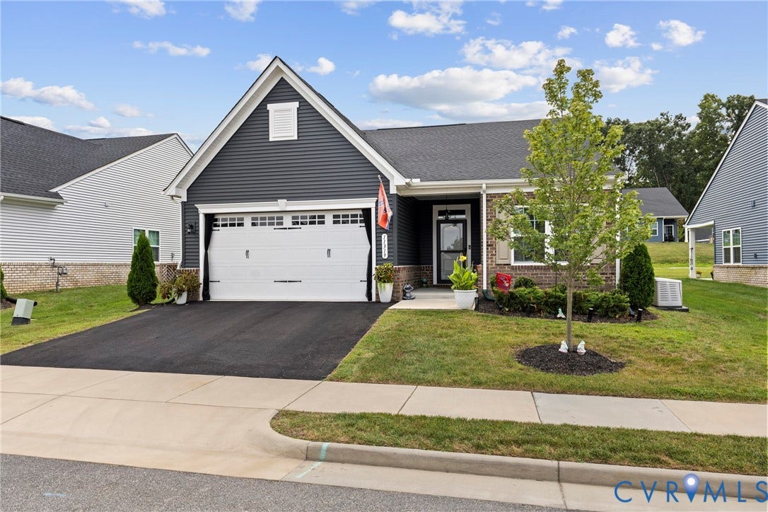 11319 Vulcan Lane, Bermuda, Chester, VA 23831 Single-story residence featuring dark siding with light trim, an attached garage, and a covered entry