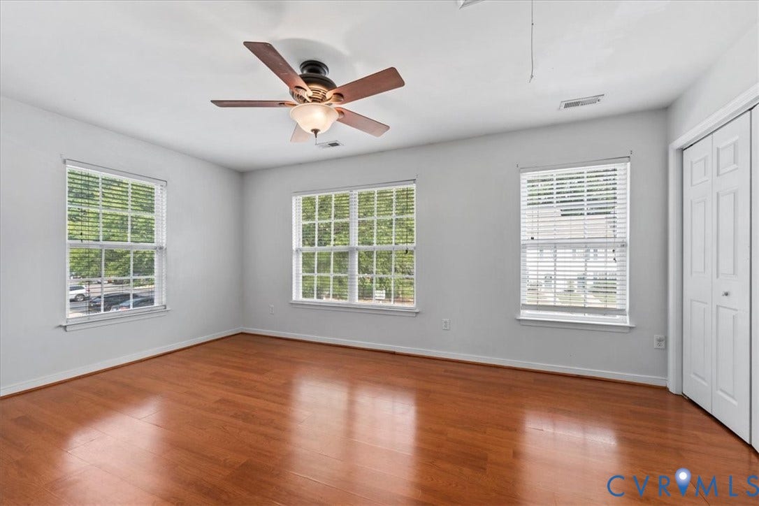2723 Goyne Terrace, Chester, VA 23831 Wood-finish flooring with multiple windows and a ceiling fan