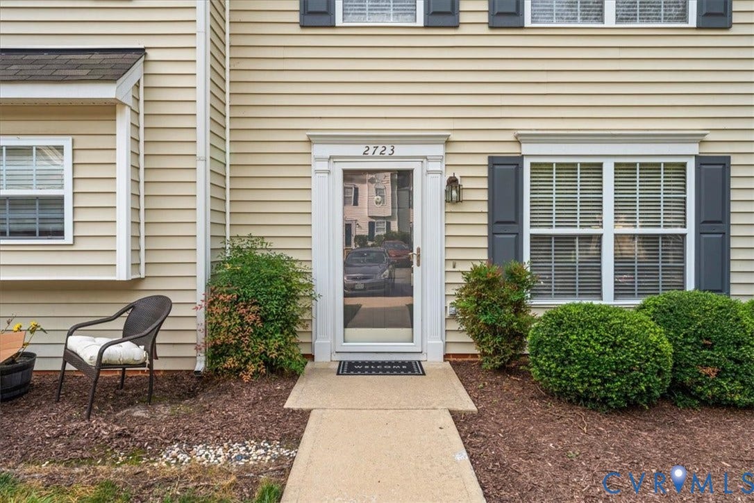 2723 Goyne Terrace, Chester, VA 23831 Beige horizontal siding facade with white window trim and dark shutters