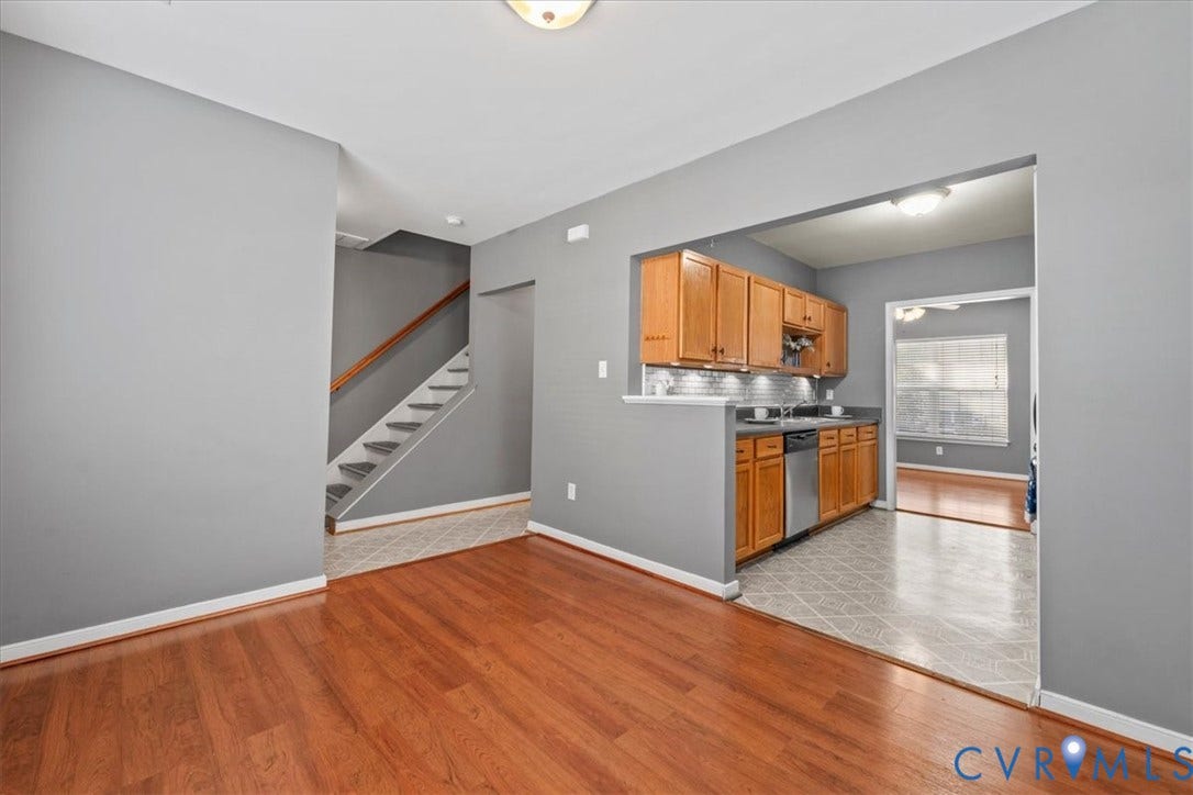 2723 Goyne Terrace, Chester, VA 23831 Cherry wood-finish flooring, staircase with wood handrail, kitchen featuring wood cabinetry, stainless steel dishwasher, and a gray tile backsplash