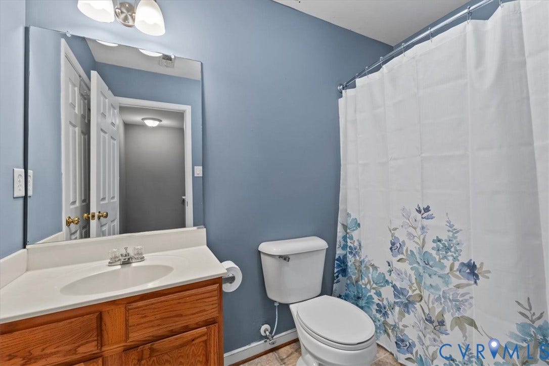 2723 Goyne Terrace, Chester, VA 23831 Wood-finish vanity with an integrated sink and chrome faucet