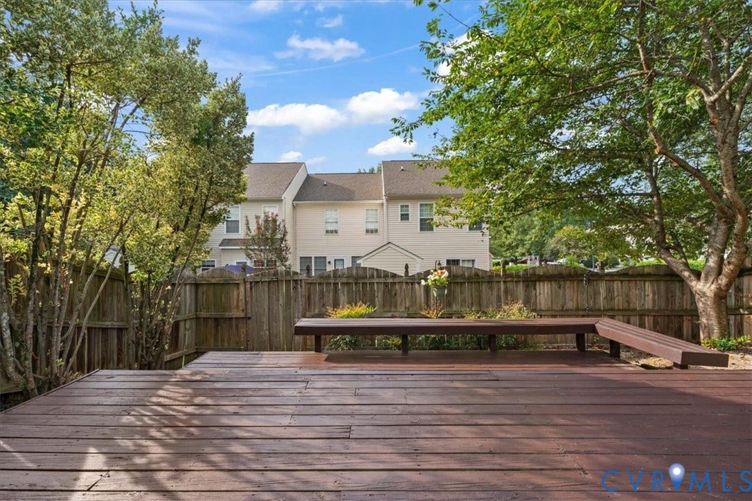 2723 Goyne Terrace, Chester, VA 23831 Spacious wood-finish decking with built-in seating, surrounded by mature trees and a wood fence