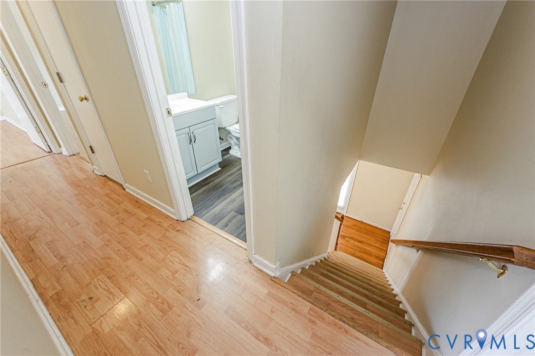 Wood-finish flooring throughout the hallway