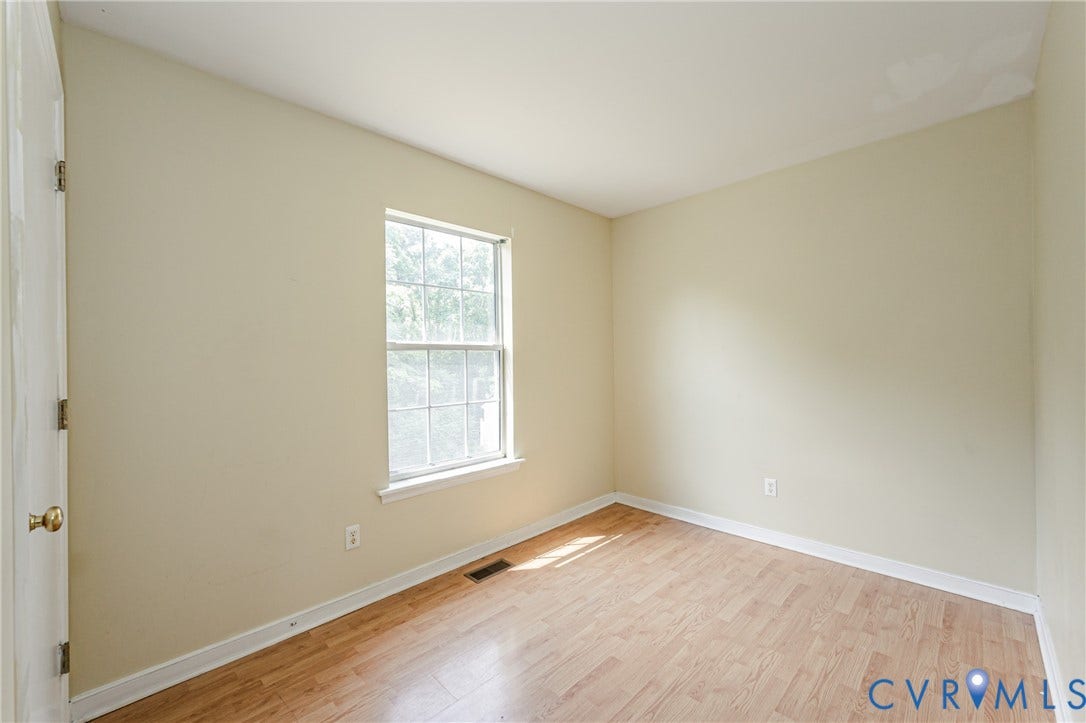 Hardwood-finish flooring, single window, and neutral wall tones